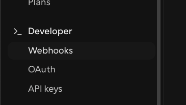 Cal.com account-level webhook settings under Settings → Developer → Webhooks